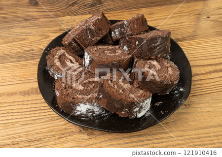 Chocolate Swiss Roll, Round Sponge Cake, Sliced Rolled Vanilla Biscuit with Cocoa Cream Filling Chocolate Swiss Roll, Round Sponge Cake, Sliced Rolled Vanilla Biscuit with Cocoa Cream Filling 121910416