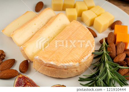 Munster cheese, stinky french cheese, creamy dairy product, gourmet food, orange cheese Munster cheese, stinky french cheese, creamy dairy product, gourmet food, orange cheese 121910444