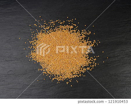 Mustard seeds isolated, dry yellow sinapis alba grains, mostarde balls on white background 121910453