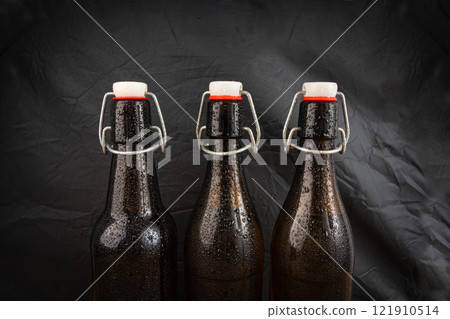 Old beer bottle, brown glass vintage beerbottle, a quality traditional time-tested drink symbol Old beer bottle, brown glass vintage beerbottle, a quality traditional time-tested drink symbol 121910514