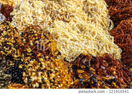 Amber stones market, polished orange gemstones closeup, natural Baltic amber gems jewelry store 121910541