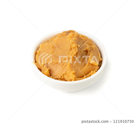 Miso paste isolated. Japanese shiro miso seasoning sauce, fermented soybean spread, brown soy cream Miso paste isolated. Japanese shiro miso seasoning sauce, fermented soybean spread, brown soy cream 121910730