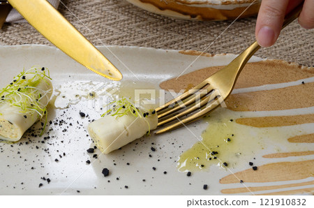 Rolls filled with cream cheese, cold appetizer, Georgian cuisine. White small cheese rolls Rolls filled with cream cheese, cold appetizer, Georgian cuisine. White small cheese rolls 121910832