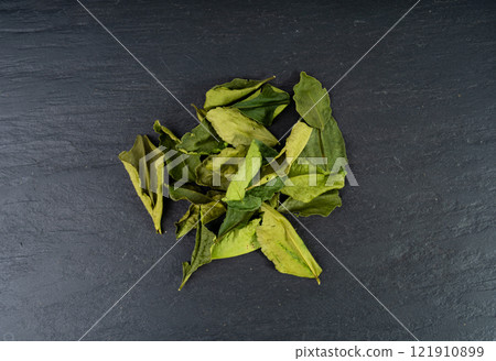 Thai lime dried leaves, makrut lime or Citrus hystrix leaf pile, kaffir lime dry sprouts, Southeast Asia spices 121910899