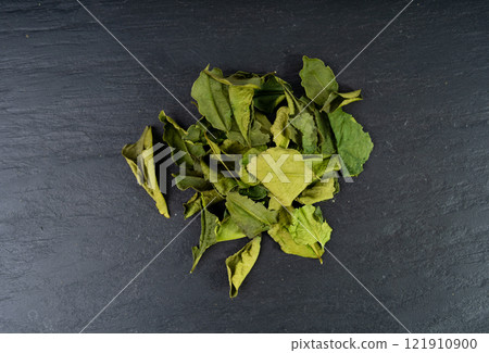 Thai lime dried leaves, makrut lime or Citrus hystrix leaf pile, kaffir lime dry sprouts, Southeast Asia spices 121910900