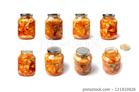 Kimchee in a glass jar isolated. Spicy kim chi, hot fermented napa cabbage, jimchi, korean gimchi Kimchee in a glass jar isolated. Spicy kim chi, hot fermented napa cabbage, jimchi, korean gimchi 121910926