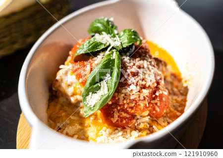 Lasagna portion, oven baked lasagne, pasta layers with cheese, minced meat, tomato in sunny summer day Lasagna portion, oven baked lasagne, pasta layers with cheese, minced meat, tomato in sunny summer day 121910960