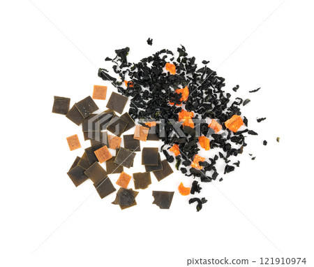 Dry kelp seaweed squares, mini wakame pieces isolated, dried kombu and carrot flakes from ramen 121910974
