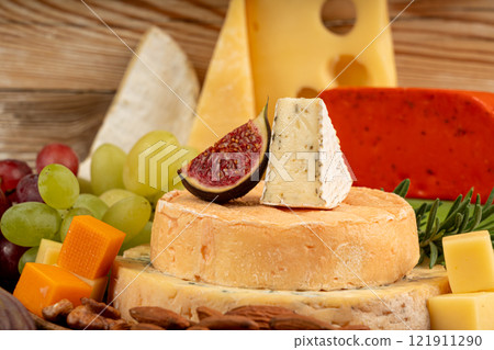 Cheese plate of color cheeses variety, yellow, white and blue cheese board, assorted dairy products Cheese plate of color cheeses variety, yellow, white and blue cheese board, assorted dairy products 121911290