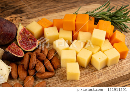 Cheese plate of color cheeses variety, yellow, white and blue cheese board, assorted dairy products Cheese plate of color cheeses variety, yellow, white and blue cheese board, assorted dairy products 121911291