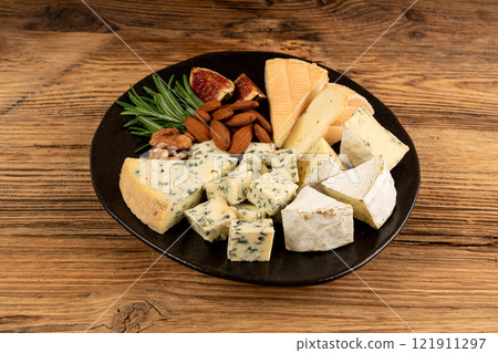 Cheese plate of color cheeses variety, yellow, white and blue cheese board, assorted dairy products Cheese plate of color cheeses variety, yellow, white and blue cheese board, assorted dairy products 121911297