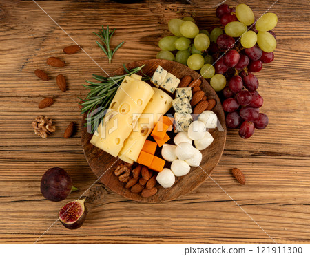 Cheese plate of color cheeses variety, yellow, white and blue cheese board, assorted dairy products Cheese plate of color cheeses variety, yellow, white and blue cheese board, assorted dairy products 121911300