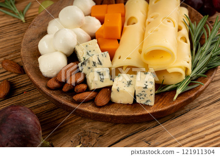 Cheese plate of color cheeses variety, yellow, white and blue cheese board, assorted dairy products Cheese plate of color cheeses variety, yellow, white and blue cheese board, assorted dairy products 121911304