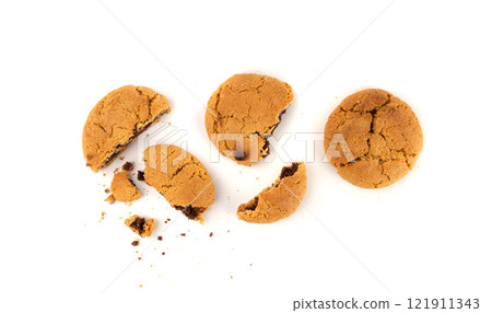 Crumbled chocolate cookies with chocolate filling isolated, brown round biscuits pieces Crumbled chocolate cookies with chocolate filling isolated, brown round biscuits pieces 121911343