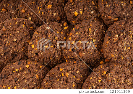 Chocolate oatmeal cookies texture background, healthy cereal oat crackers with nuts pattern Chocolate oatmeal cookies texture background, healthy cereal oat crackers with nuts pattern 121911369