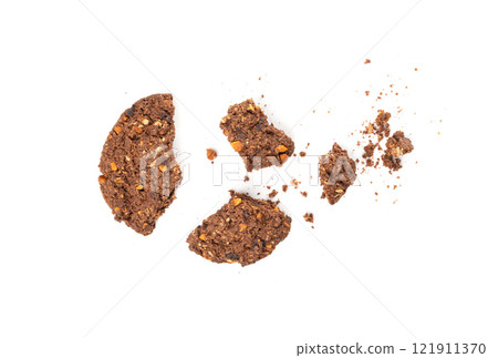 Crumbled chocolate oatmeal cookies isolated, broken cereal oat crackers with nuts Crumbled chocolate oatmeal cookies isolated, broken cereal oat crackers with nuts 121911370