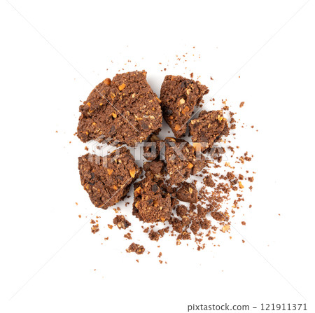Crumbled chocolate oatmeal cookies isolated, broken cereal oat crackers with nuts Crumbled chocolate oatmeal cookies isolated, broken cereal oat crackers with nuts 121911371