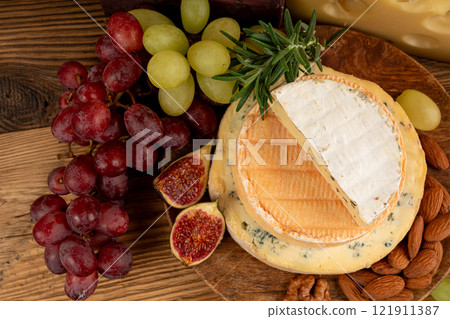 Cheese plate of color cheeses variety, yellow, white and blue cheese board, assorted dairy products Cheese plate of color cheeses variety, yellow, white and blue cheese board, assorted dairy products 121911387