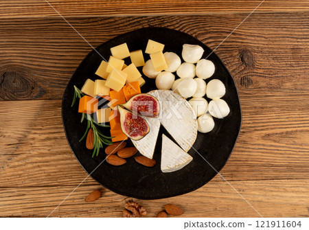 Cheese plate of color cheeses variety, yellow, white and blue cheese board, assorted dairy products Cheese plate of color cheeses variety, yellow, white and blue cheese board, assorted dairy products 121911604