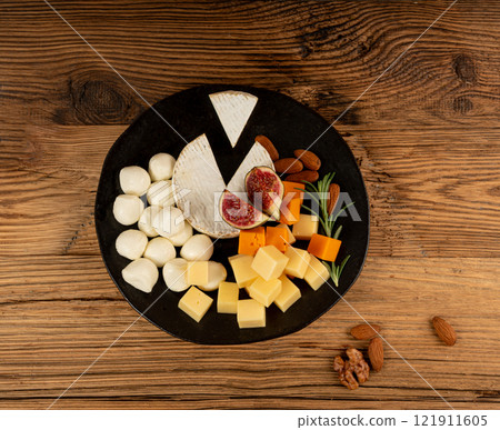 Cheese plate of color cheeses variety, yellow, white and blue cheese board, assorted dairy products 121911605
