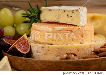 Cheese plate of color cheeses variety, yellow, white and blue cheese board, assorted dairy products Cheese plate of color cheeses variety, yellow, white and blue cheese board, assorted dairy products 121911608