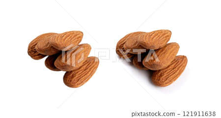 Almonds pile isolated, nut group, almond seeds, brown scattered fruit kernels on white background Almonds pile isolated, nut group, almond seeds, brown scattered fruit kernels on white background 121911638