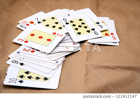 A deck of poker cards spread out on a table. 121912147