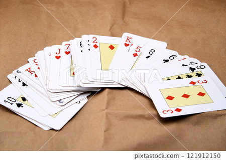 A deck of poker cards spread out on a table. 121912150