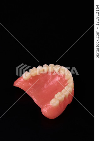 A detailed view of dentures against a dark backdrop 121912164