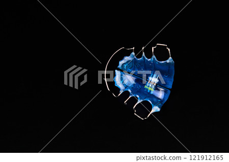 A detailed view of a blue item against a dark backdrop 121912165