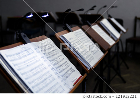 Music stands with musical notes in a rehearsal room Music stands with musical notes in a rehearsal room 121912221