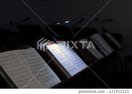 Music stands with musical notes in a rehearsal room Music stands with musical notes in a rehearsal room 121912223