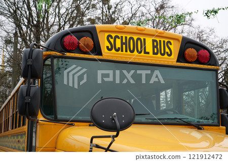 School bus stands in parking lot near the school in USA School bus stands in parking lot near the school in USA 121912472