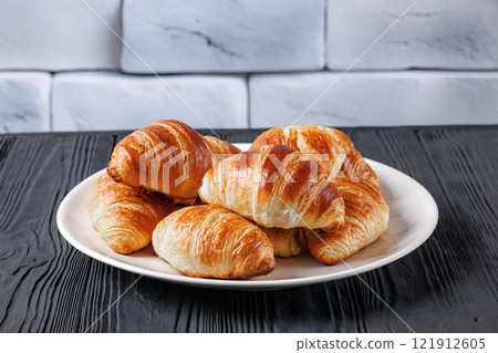 freshly baked in oven croissants on a plate freshly baked in oven croissants on a plate 121912605