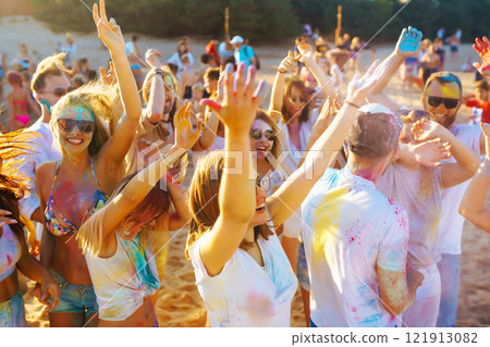 A group of friends have fun, dance at the holi festival. Celebrating traditional indian spring holiday. Friendship. 121913082