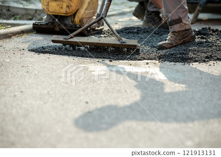 Closeup of patching a bump in the road Closeup of patching a bump in the road 121913131