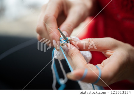 Closeup view of a woman knitting Closeup view of a woman knitting 121913134