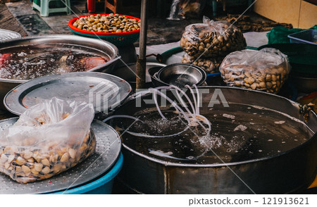 A vibrant and lively market scene filled with an array of seafood and fresh produce on display A vibrant and lively market scene filled with an array of seafood and fresh produce on display 121913621