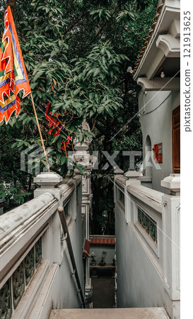 Pathway Winding Through Lush Greenery Adorned with Colorful Flags in Hanoi 121913625