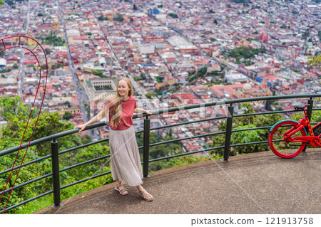 Female tourist in front of the panoramic view of Orizaba from Cerro del Borrego, Mexico. Travel, scenic landscape, and adventure concept 121913758