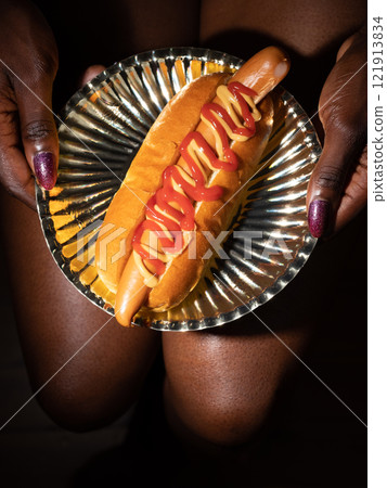 Hot dog on a golden plate 121913834