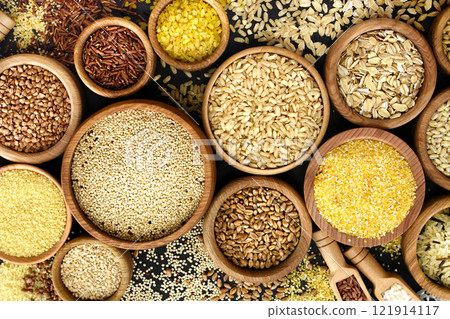 Colorful mix of grain varieties: oat and wheat, rice and millet, buckwheat and barley, quinoa and polenta. Food ingridients for healthy diet background, selective focus 121914117