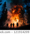 Fire brigade extinguishes a forest fire in the night forest 121914209