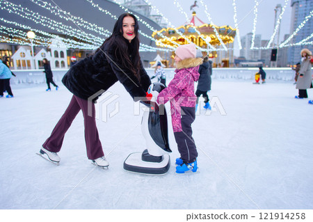 Winter ice skating fun at a festive outdoor rink in the city Winter ice skating fun at a festive outdoor rink in the city 121914258