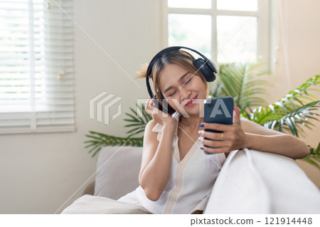Relaxing moment listening to music at home indoor cozy atmosphere close-up view personal enjoyment 121914448