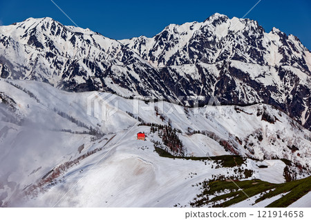 Snow-covered Mount Tsurugi and Taneike Sanso mountain lodge seen from the southern ridge of Mount Jigatake in the Northern Alps Snow-covered Mount Tsurugi and Taneike Sanso mountain lodge seen from the southern ridge of Mount Jigatake in the Northern Alps 121914658