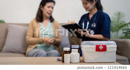 Caregiver consults elderly patient home setting medical guidance warm atmosphere compassionate approach Caregiver consults elderly patient home setting medical guidance warm atmosphere compassionate approach 121914668