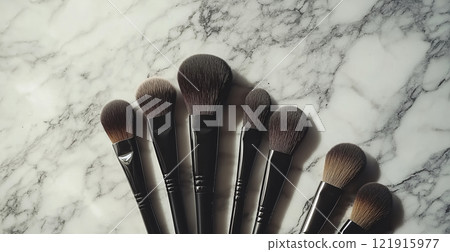 A set of makeup brushes neatly arranged on a marble background 121915977