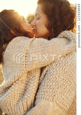 Family in a summer field. Sensual photo. Cute little girl in a knited sweater. 121916684