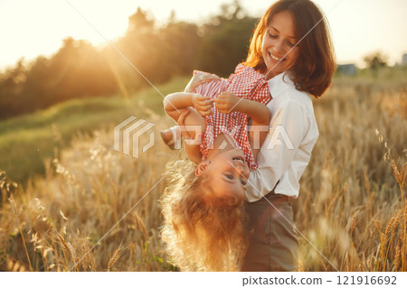 Family in a summer field. Sensual photo. Cute little girl. 121916692